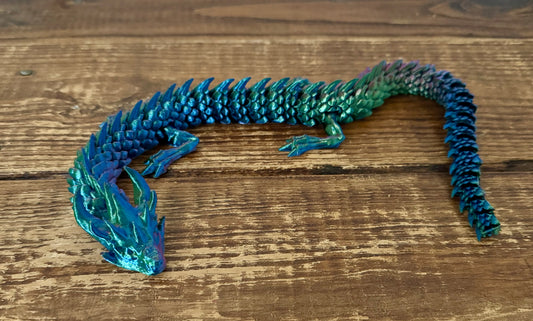 Blue dragon toy on a wooden surface