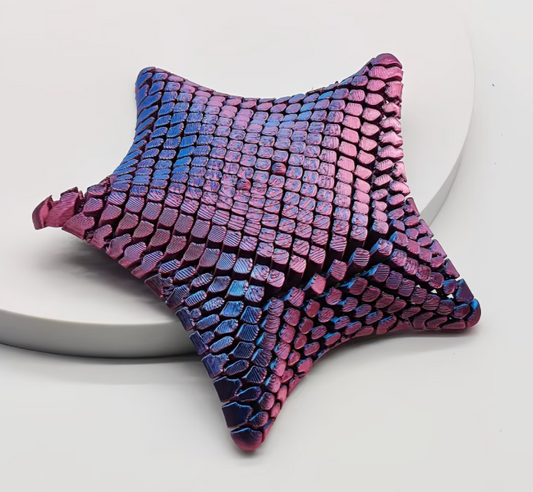 3D printed flexible poseable starfish fidget with articulated segments and purple and blue color shifting finish on a white background