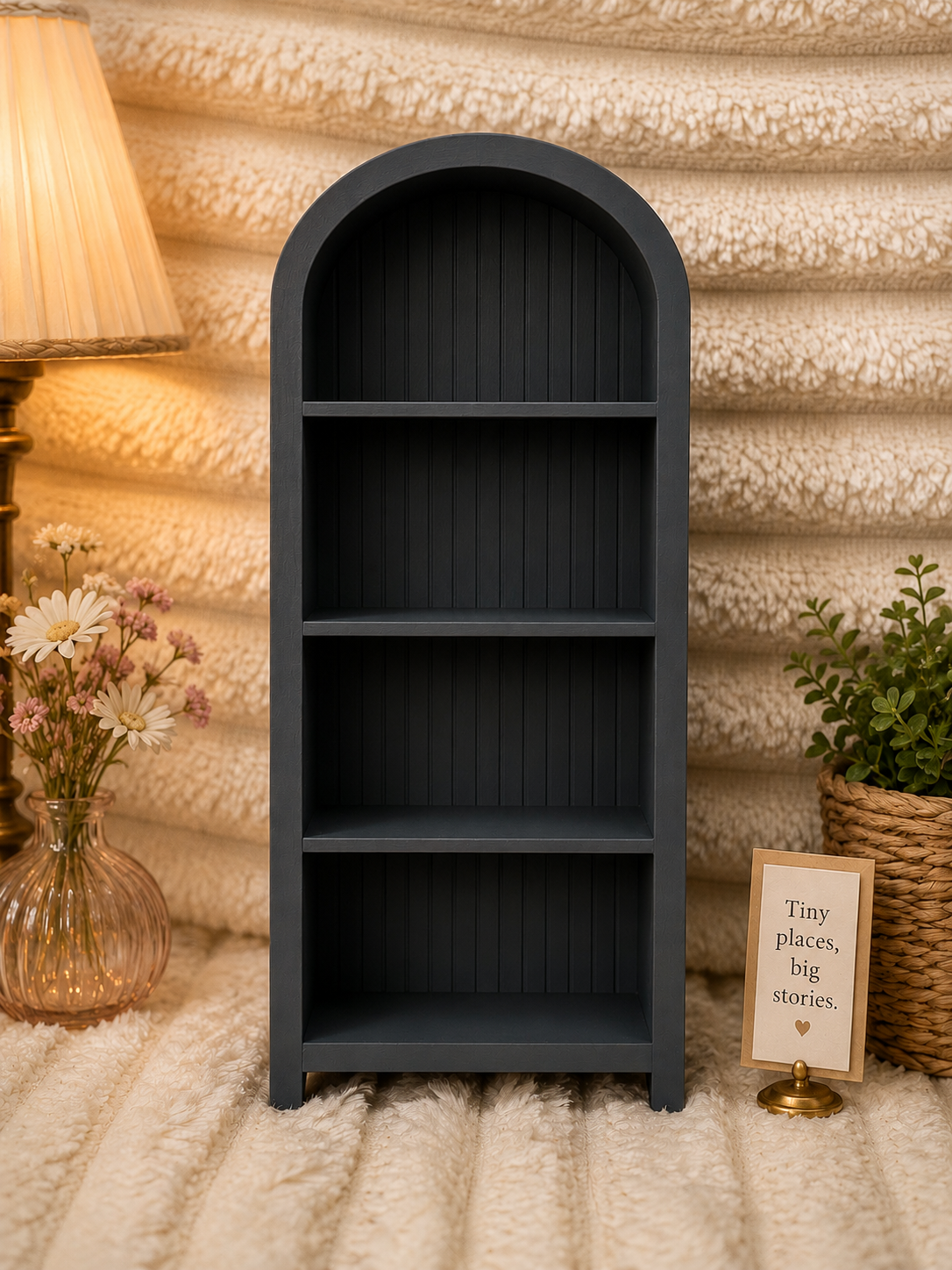 Gray wooden bookshelf against a textured wall with decorative elements.