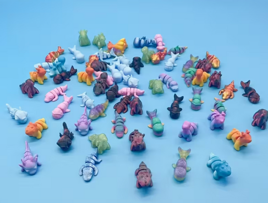 assorted 3d printed miniature animals in multiple colors on a blue background