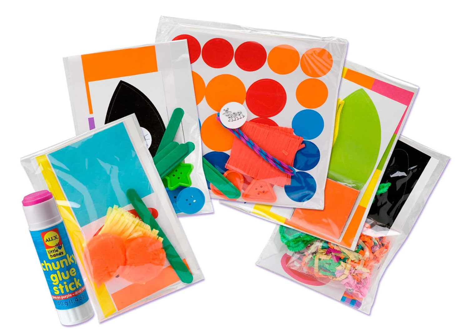 Colorful craft supplies including stickers and a glue stick on a white background