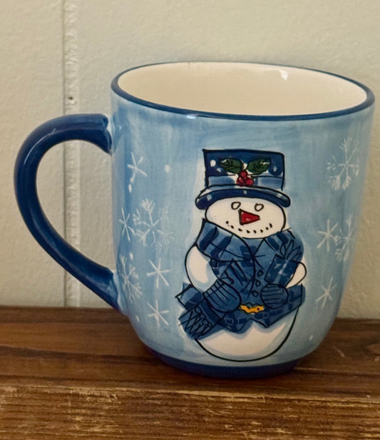 Blue ceramic mug featuring a snowman design, perfect for holiday or wintertime drinks