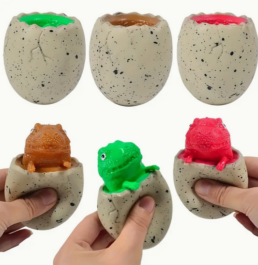 Dinosaur egg toys with different colored tops and small dinosaurs inside, held by hands.