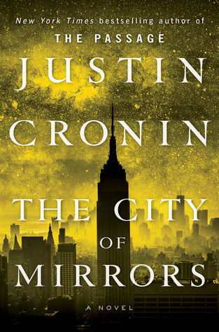 Cover of The City of Mirrors by Justin Cronin, featuring a golden-hued skyline with the silhouette of the Empire State Building, evoking a post-apocalyptic atmosphere.