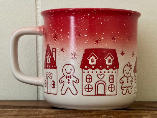 Ceramic Christmas mug with colorful gingerbread houses and a gingerbread man, festive holiday drinkware