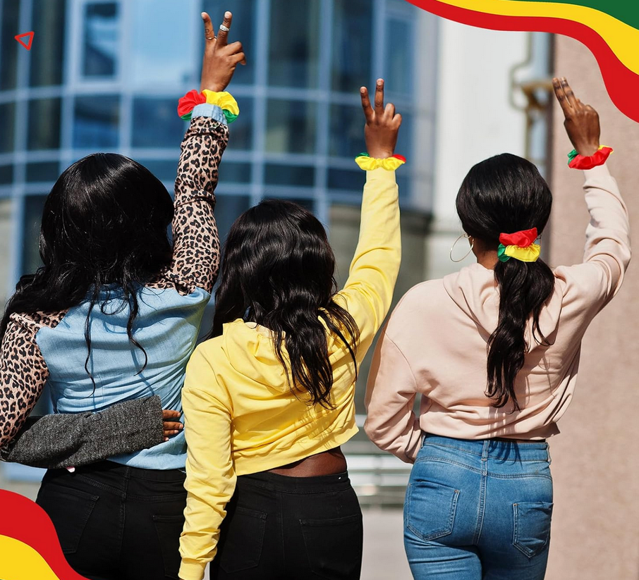 Red, yellow, and green satin hair scrunchies inspired by Juneteenth and African heritage