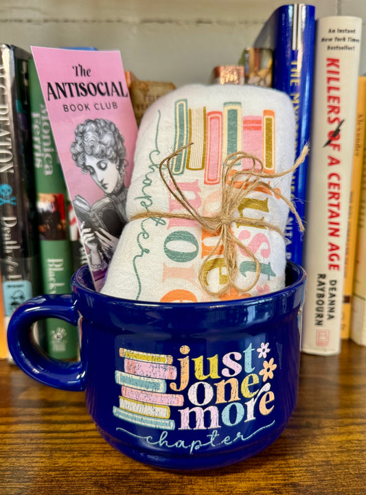 Gift bundle including a large mug and tea towel both labeled Just One More Chapter, with a bonus bookmark tucked inside