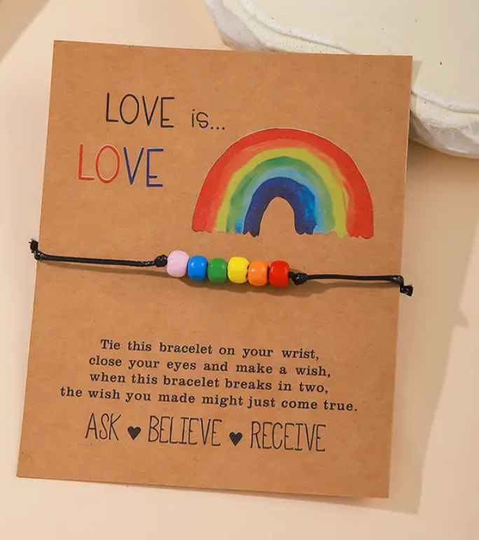 Rainbow string Pride bracelet on a card that says Love is Love with a wish-making affirmation