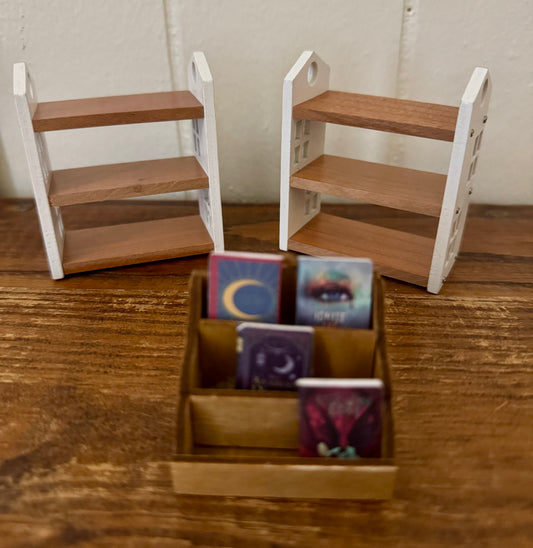 Miniature wooden shelves with books on a wooden surface