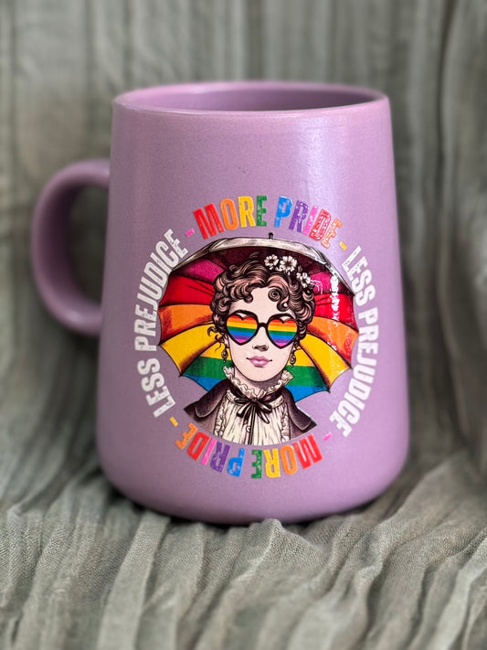 Ceramic mug with rainbow text reading More Pride Less Prejudice, celebrating LGBTQ+ pride and inclusion