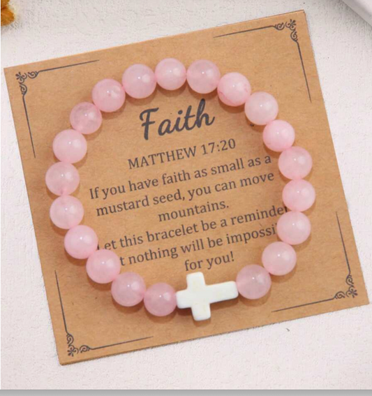 Pink beaded bracelet with a white cross on a card with inspirational text