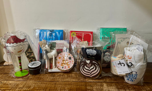 Pre-made gift bags with various themes: Christmas, romance, mystery, coffee, wine, and cozy. Includes books, bookmarks, candles, socks, and more.