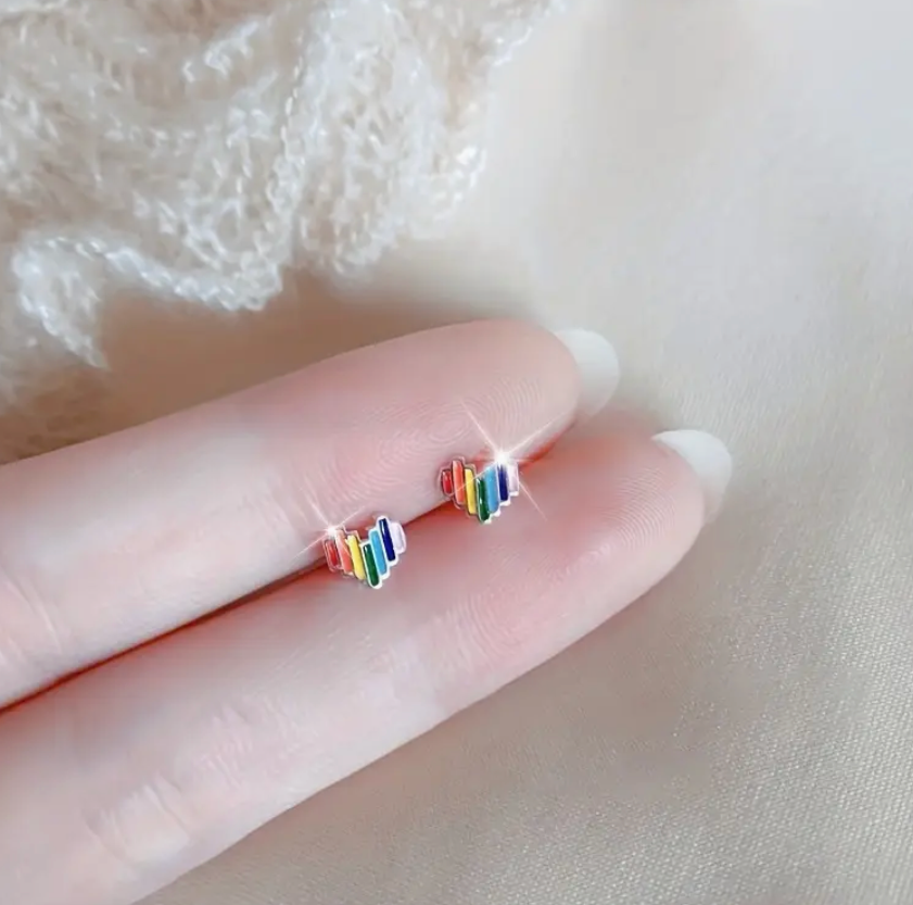 Pair of small rainbow heart-shaped stud earrings made from lightweight alloy