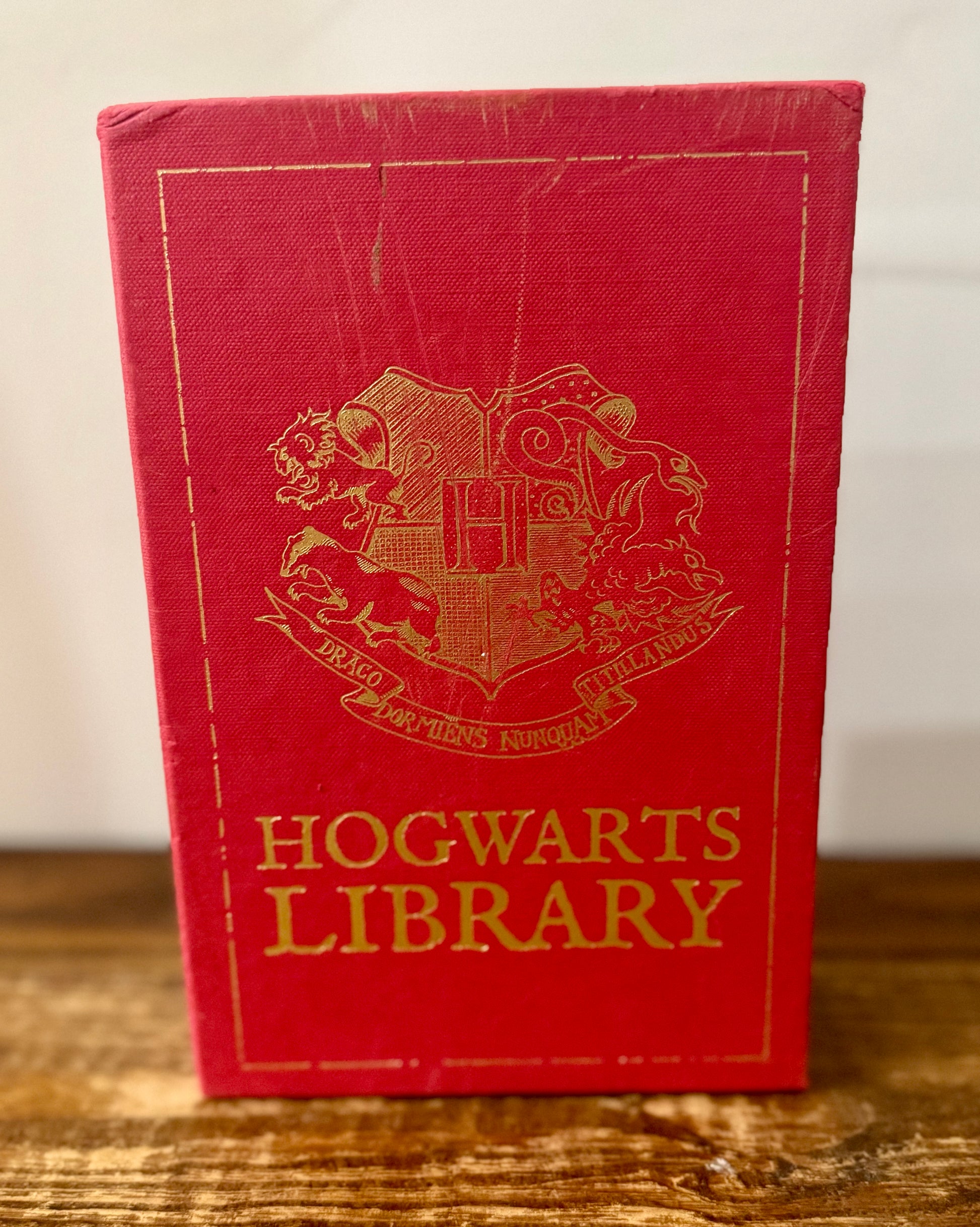 Cover of Hogwarts Library 3-book collection by J.K. Rowling, featuring Fantastic Beasts and Where to Find Them, Quidditch Through the Ages, and The Tales of Beedle the Bard in a themed slipcase.