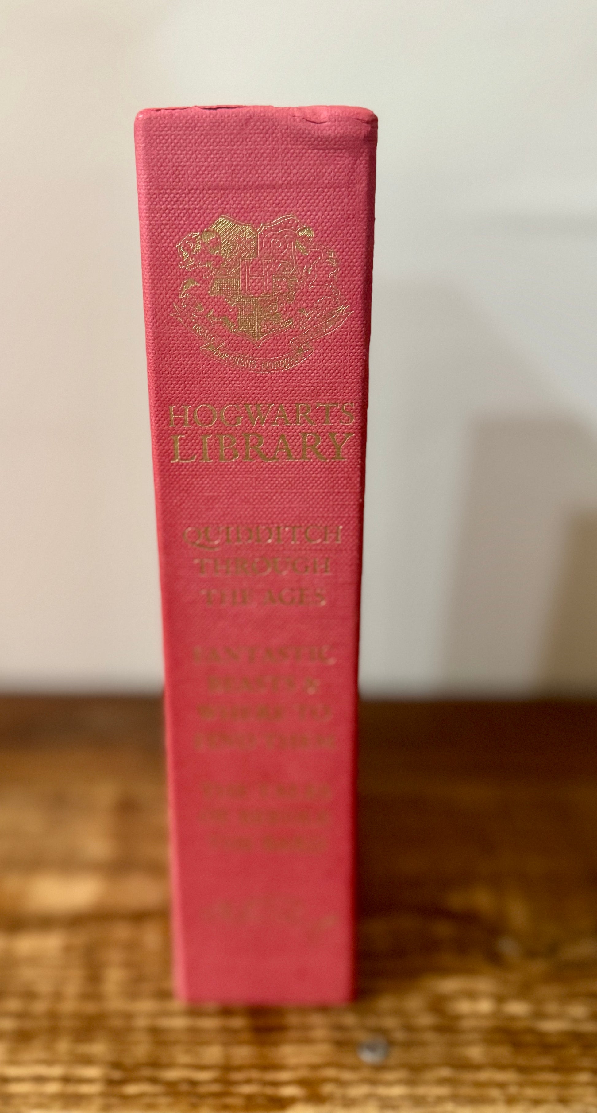 Cover of Hogwarts Library 3-book collection by J.K. Rowling, featuring Fantastic Beasts and Where to Find Them, Quidditch Through the Ages, and The Tales of Beedle the Bard in a themed slipcase.