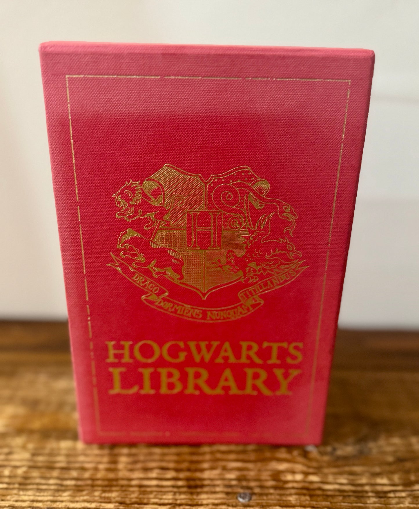 Cover of Hogwarts Library 3-book collection by J.K. Rowling, featuring Fantastic Beasts and Where to Find Them, Quidditch Through the Ages, and The Tales of Beedle the Bard in a themed slipcase.