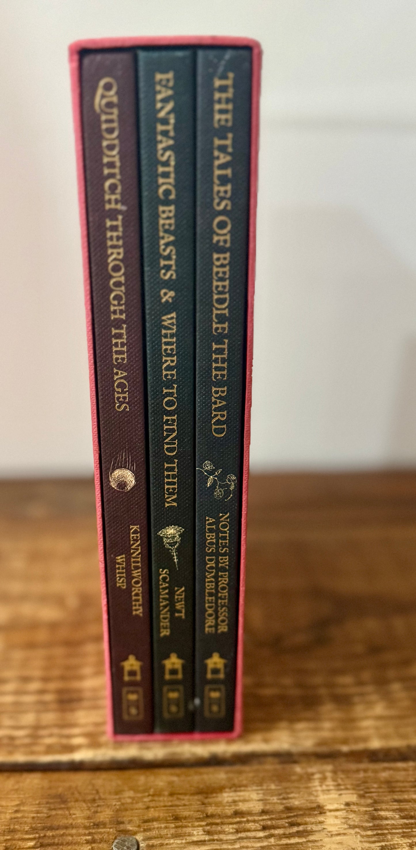 Cover of Hogwarts Library 3-book collection by J.K. Rowling, featuring Fantastic Beasts and Where to Find Them, Quidditch Through the Ages, and The Tales of Beedle the Bard in a themed slipcase.