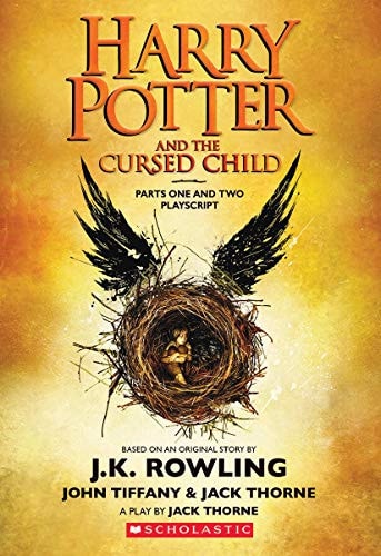 Front cover of Harry Potter and the Cursed Child by J. K. Rowling featuring a golden nest with wings cradling a child against a dramatic background