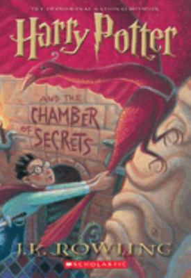 Front cover of Harry Potter and the Chamber of Secrets by J.K. Rowling, featuring Harry and a phoenix in a glowing underground chamber.