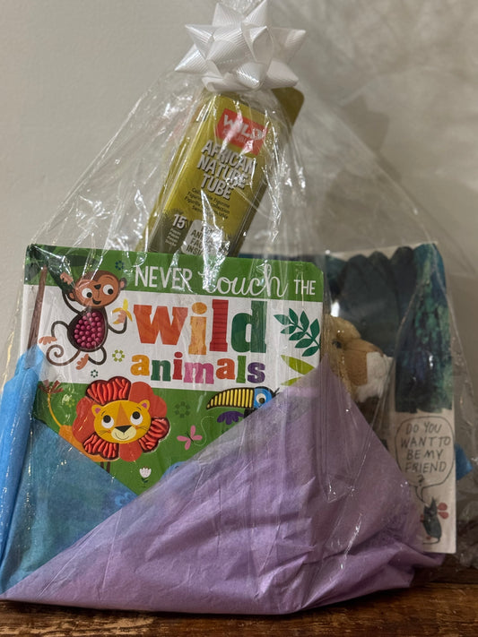 Gift basket with two children's books, a roaring stuffed lion, and 15 small safari animal figurines—perfect for young animal lovers and adventurers.