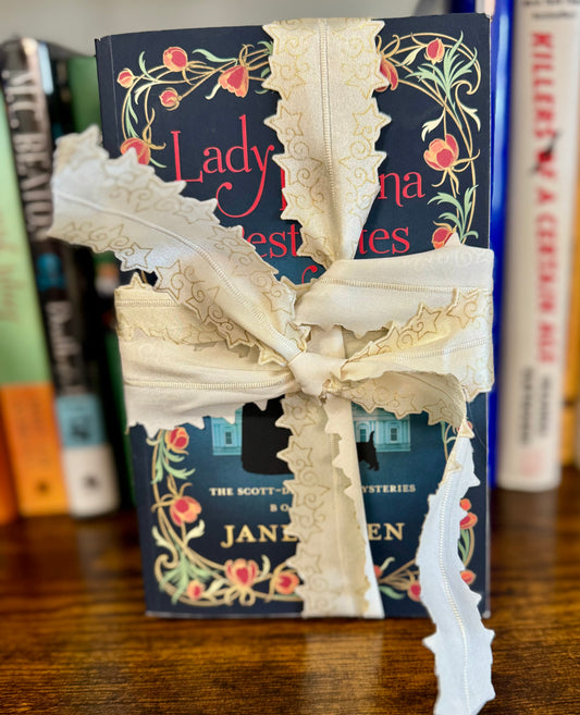 Book bundle tied with ribbon featuring Lady Helena Investigates and Lady Odelia’s Secret, the first two books in the Scott-De Quincy Mysteries
