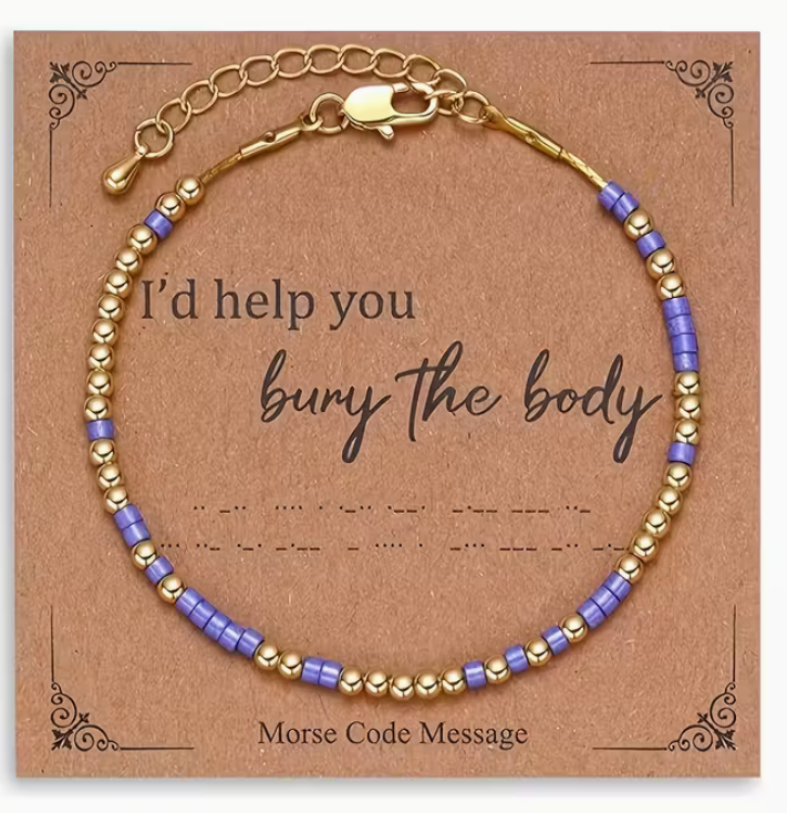 Purple and gold Morse code bracelet displayed on a kraft message card that reads I’d help you bury the body.