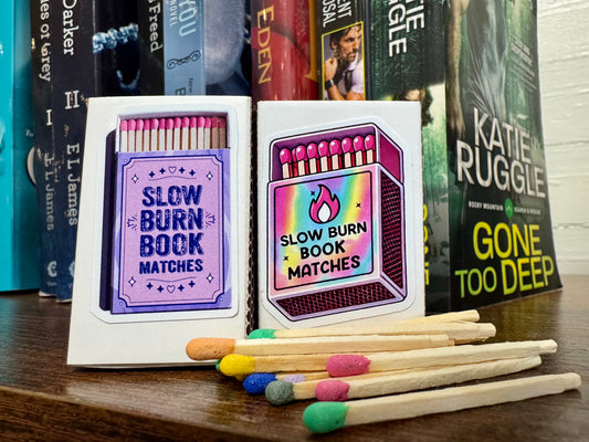 Small matchbox labeled Slow Burn containing approximately 15 colorful matchbook matches