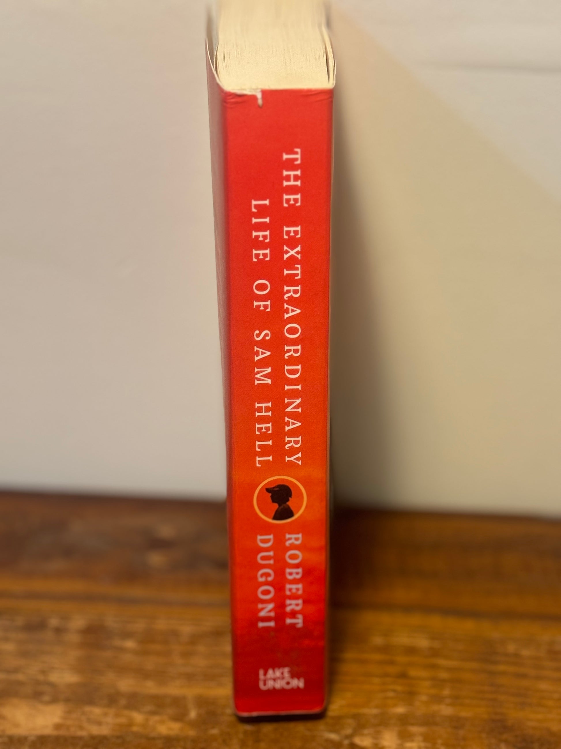 Paperback copy of Robert Dugoni’s The Extraordinary Life of Sam Hell in like new condition, an inspirational contemporary novel.