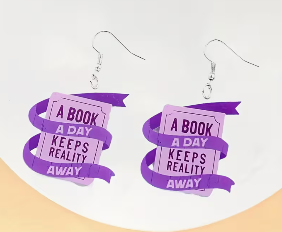 Purple book lover dangle earrings reading A Book a Day Keeps Reality Away