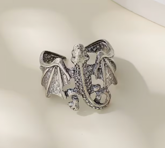 Front view of adjustable silver-toned dragon ring with detailed wings, curled tail, and textured dragon body