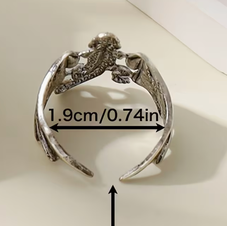 Back view of adjustable silver-toned dragon ring showing open band and interior width measurement of 1.9 cm