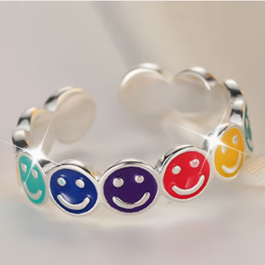 Adjustable silver tone ring featuring colorful enamel smiley faces in blue, purple, red, yellow, and green on an open adjustable band