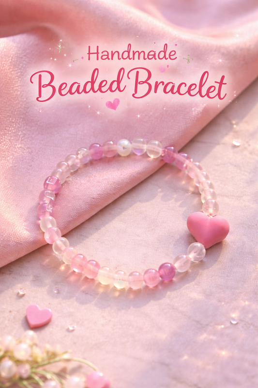 Handmade beaded bracelet with pink hearts on a soft pink fabric background