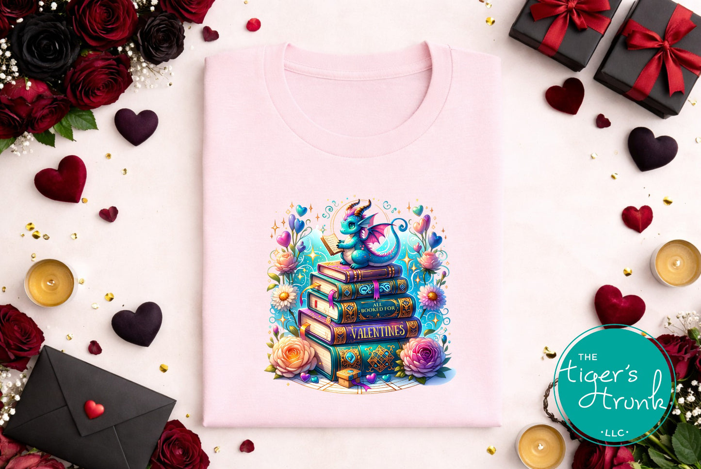 Pink sweatshirt with a colorful design surrounded by flowers, hearts, and gift boxes on a white background.