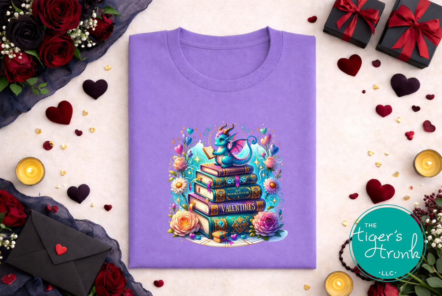Purple t-shirt with a colorful design of books and a dragon, surrounded by decorative elements like flowers and gift boxes.
