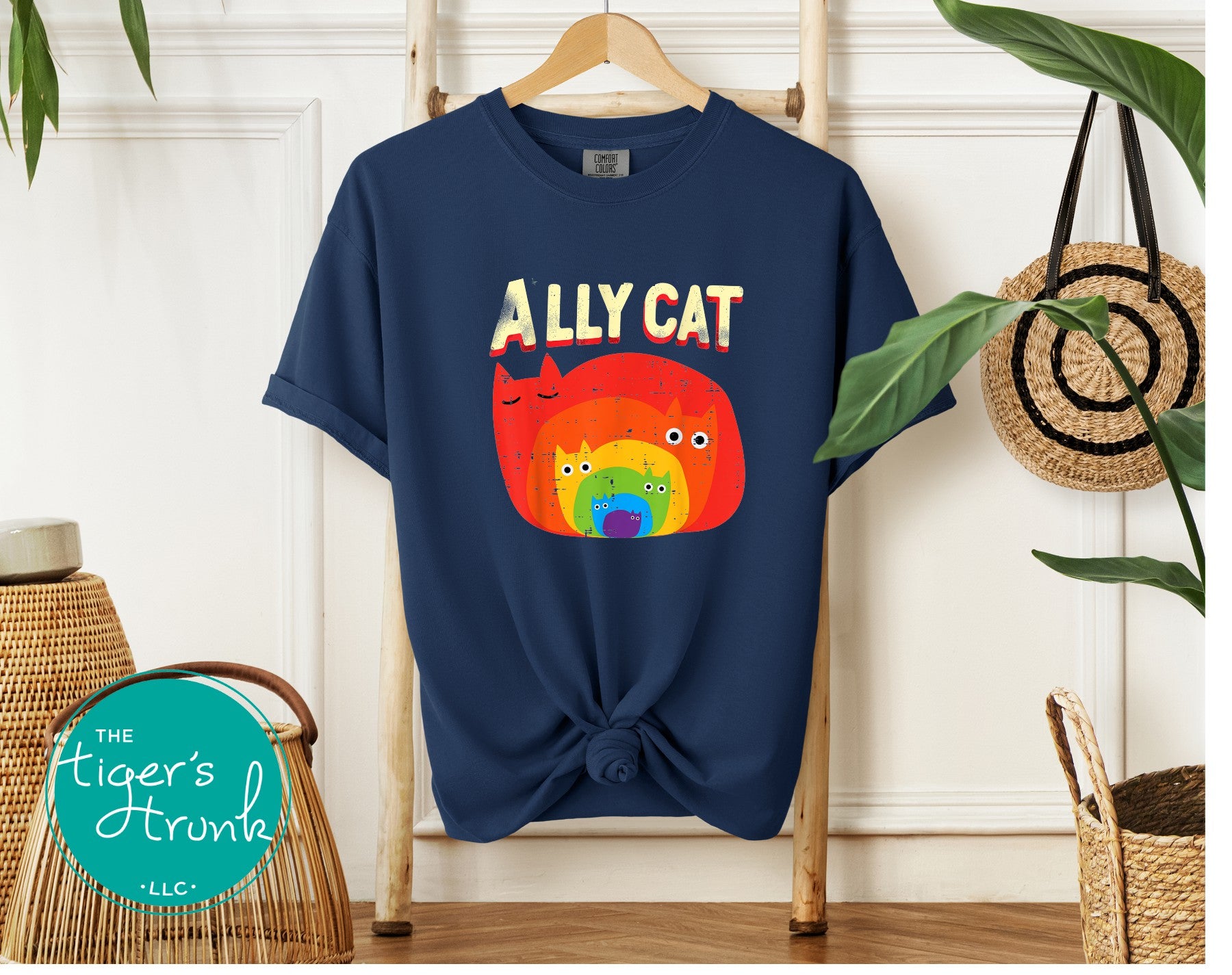 Midnight blue Ally Cat rainbow cat graphic shirt tied in front on wooden ladder display