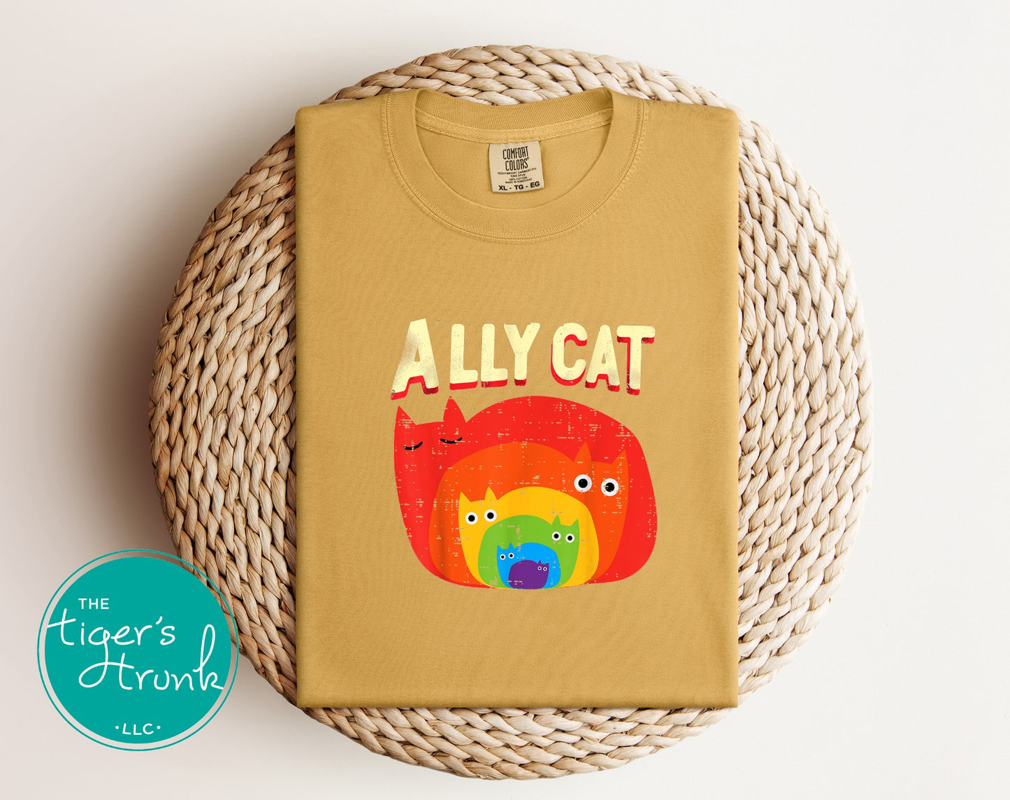 Mustard yellow Ally Cat rainbow cat shirt folded flatlay with colorful retro kitty artwork