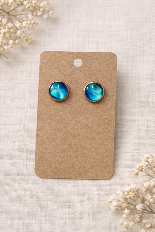 Blue aurora stainless steel stud earrings displayed on kraft jewelry card