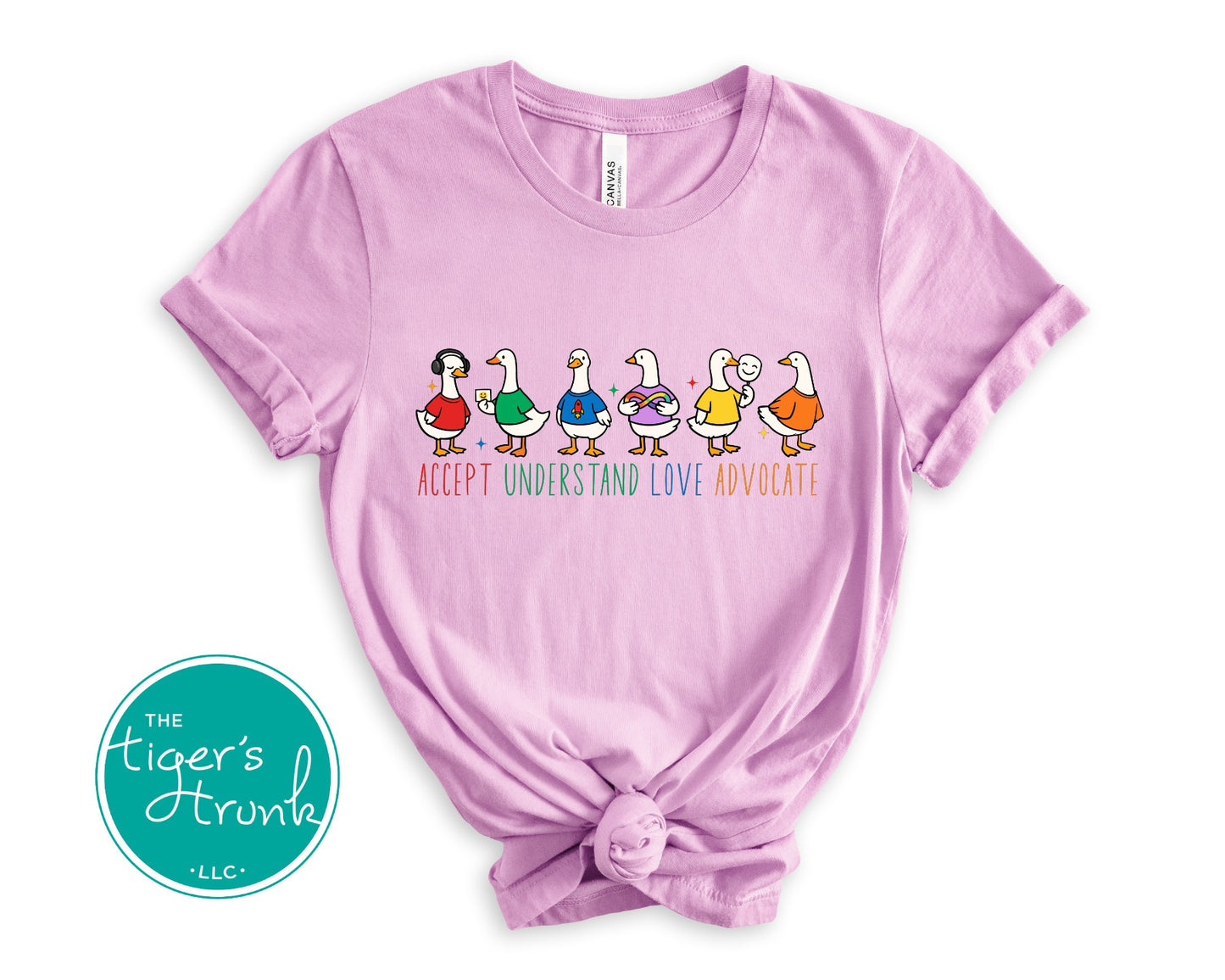 Lilac t-shirt with colorful duck illustrations and text on a white background, featuring 'The Tiger's Artruh' logo.