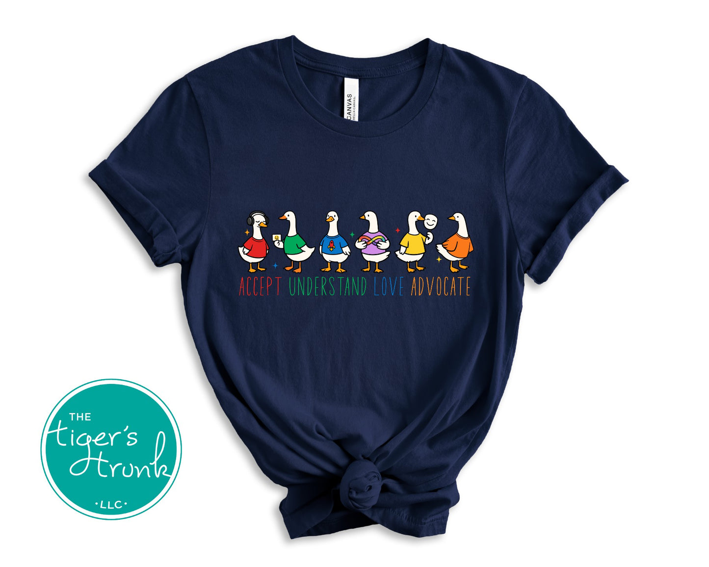 Navy blue t-shirt with colorful duck illustrations and text on a white background, featuring the 'Tiger's Trunk' logo.