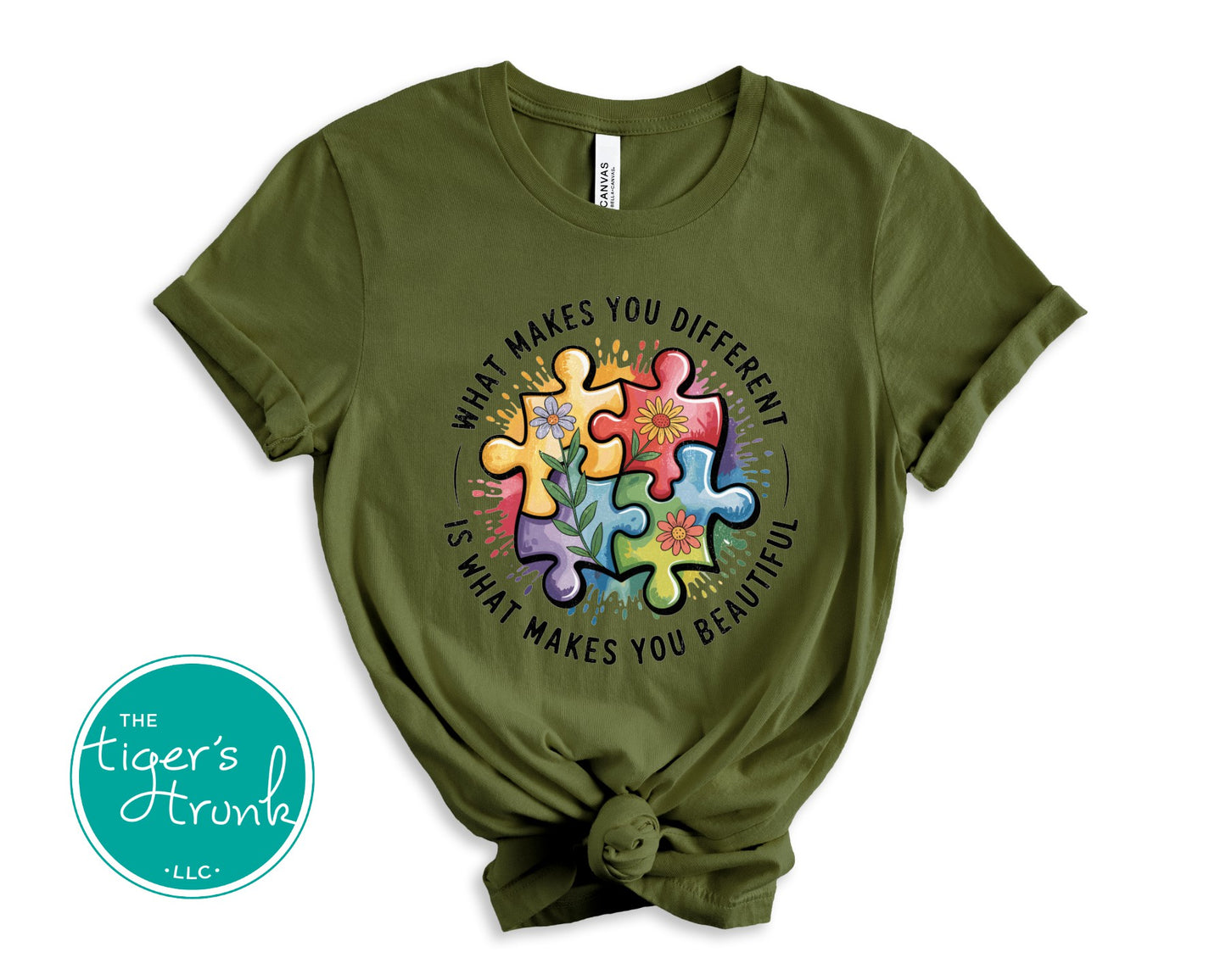 Green t-shirt with colorful puzzle piece design and text on a white background, featuring the 'Tiger's Trunk' logo.