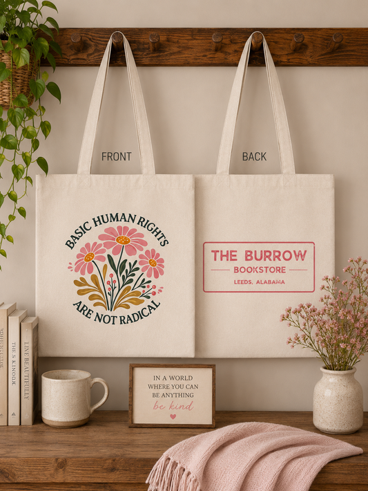 Natural canvas two-sided tote bag featuring a Basic Human Rights Are Not Radical floral design on the front and The Burrow Bookstore logo on the back.