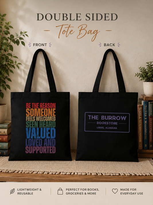 Black canvas tote bag featuring the Be the Reason Someone Feels Welcomed inspirational design on the front and The Burrow Bookstore logo on the back.