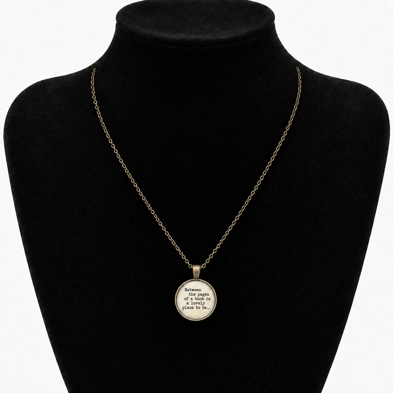 Vintage brown metal book lover necklace with glass pendant reading Between the pages of a book is a lovely place to be.