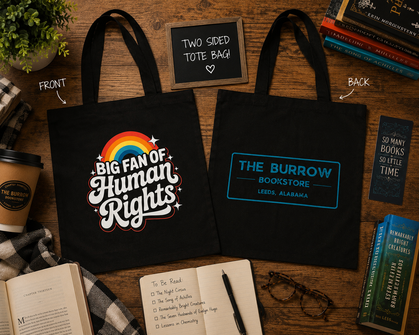 Black two-sided canvas tote featuring a colorful Big Fan of Human Rights design on the front and The Burrow Bookstore logo on the back.