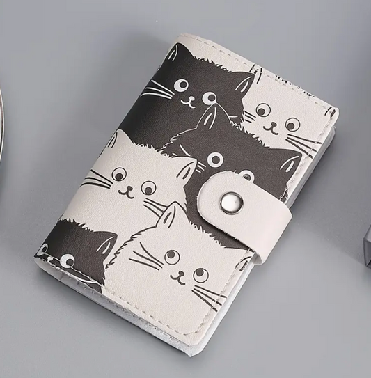 Cardholder with black and white cat illustrations on a gray background