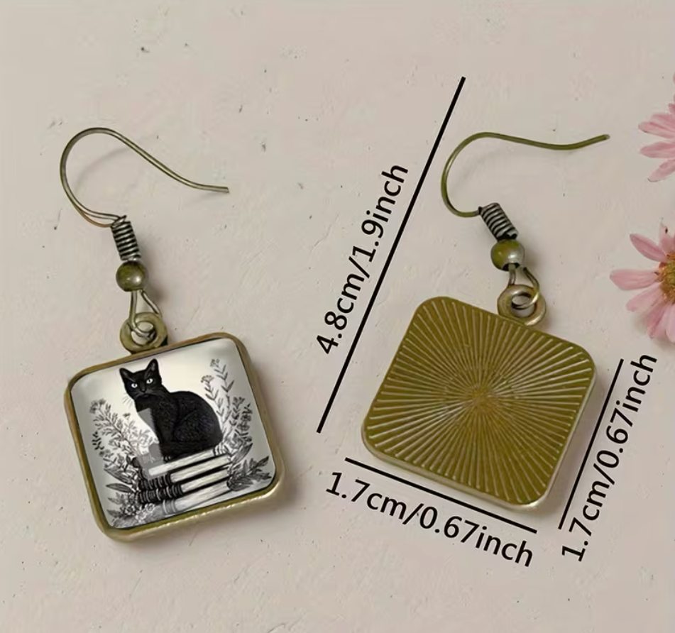Retro black cat and books square dangle earrings measuring approximately 1.9 inches long with 0.67 inch charms