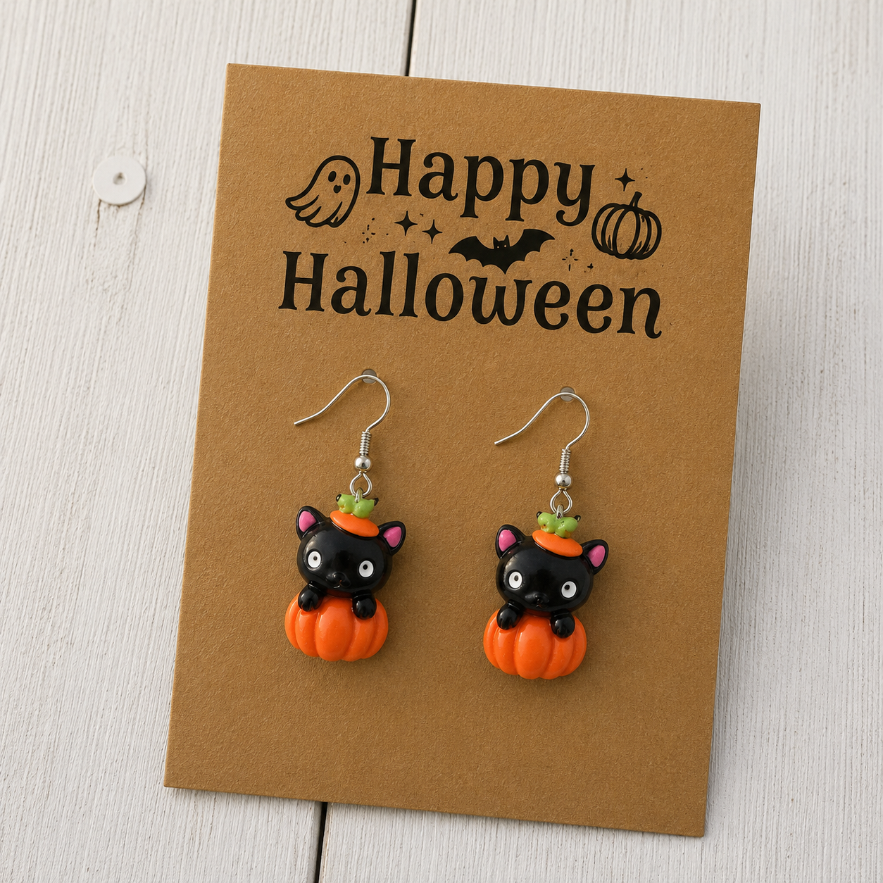 Black cat and orange pumpkin resin dangle earrings with silver-tone hooks for Halloween.