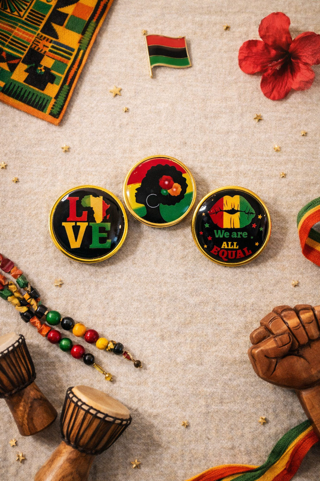 Colorful buttons with messages of love and equality, surrounded by African-themed items on a textured surface.