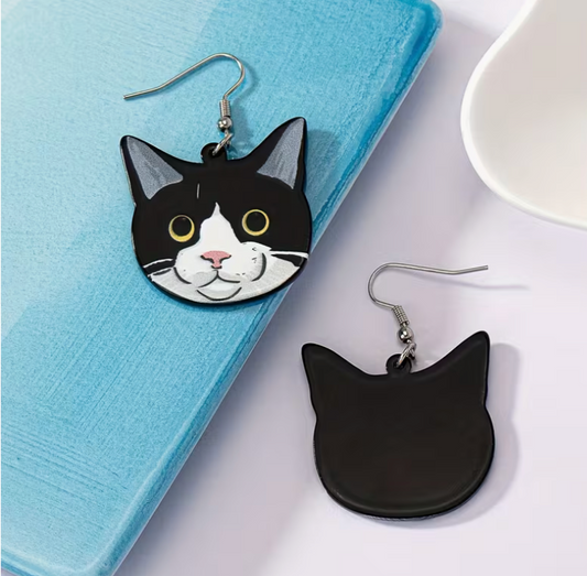 front and back view of black and white tuxedo cat acrylic earrings with glossy lightweight design